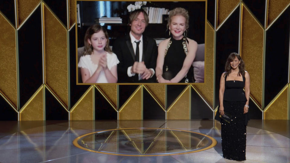 In this video grab issued Sunday, Feb. 28, 2021, by NBC, Nicole Kidman, nominee for best actress in a limited series for "The Undoing" appears on screen, from right, with her husband Keith Urban and their daughter Faith Margaret Kidman Urban as presenter Rosie Perez looks on at the Golden Globe Awards. (NBC via AP)