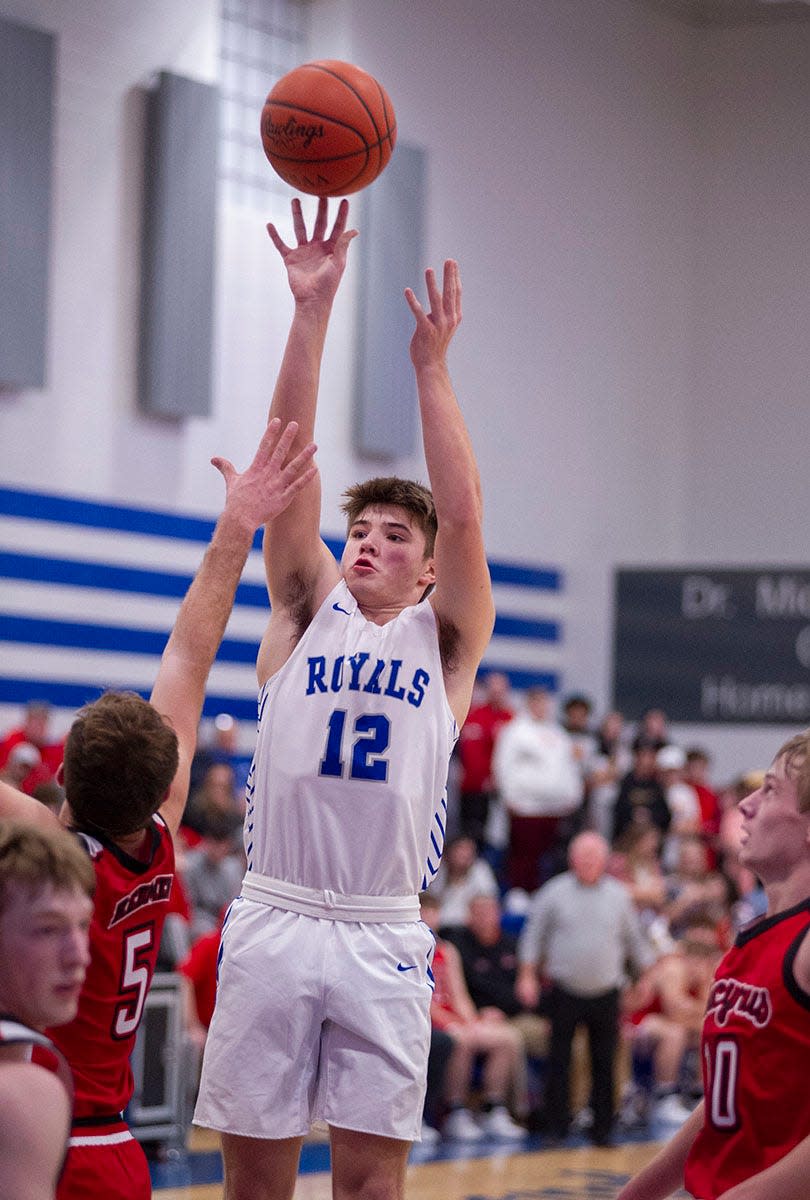 Wynford's Grant McGuire elevates over Bucyrus' Mike Wise for a bucket.