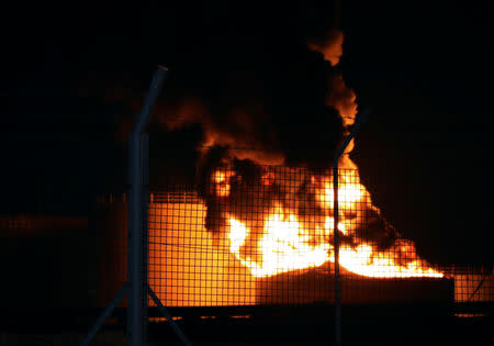 Fire engulfs an oil storage tank at the Aden oil refinery following an explosion in Aden, Yemen January 11, 2019. REUTERS/Fawaz Salman