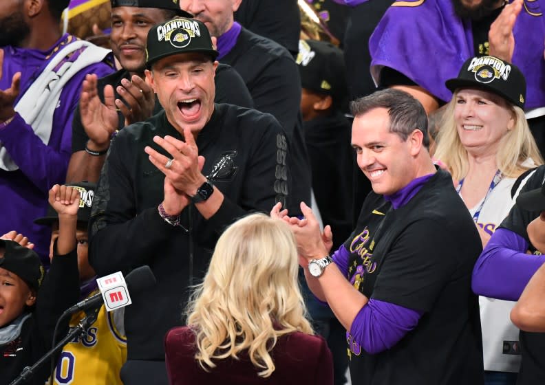 ORLANDO, FLORIDA OCTOBER 11, 2020- Lakers GM Rob Pelinka, left, and head coach Frank Vogel celebrate with owner Jeannie Buss, center, after winning the NBA Championship in Game 6 of the NBA FInals in Orlando Sunday. (Wally Skalij/Los Angeles Times)