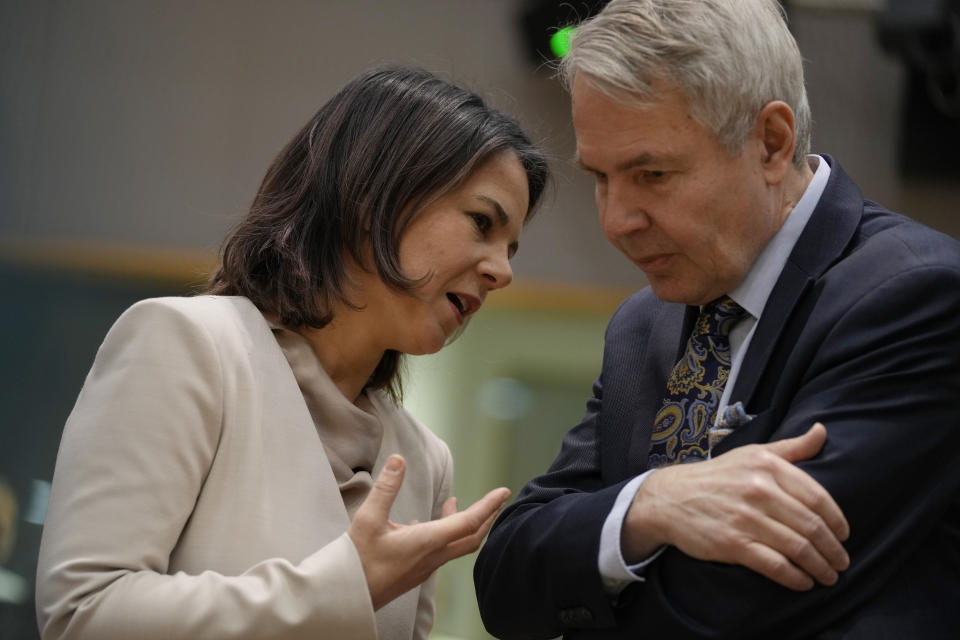 Germany's Foreign Minister Annalena Baerbock, left, speaks with Finland's Foreign Minister Pekka Haavisto during a meeting of EU foreign ministers at the European Council building in Brussels on Monday, Jan. 23, 2023. (AP Photo/Virginia Mayo)