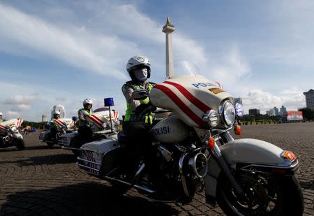 Female traffic police depart on their motorcycles following a security briefing at the National Monument before deployment during the Christmas and New Year holidays in Jakarta, Indonesia December 22, 2016. REUTERS/Darren Whiteside