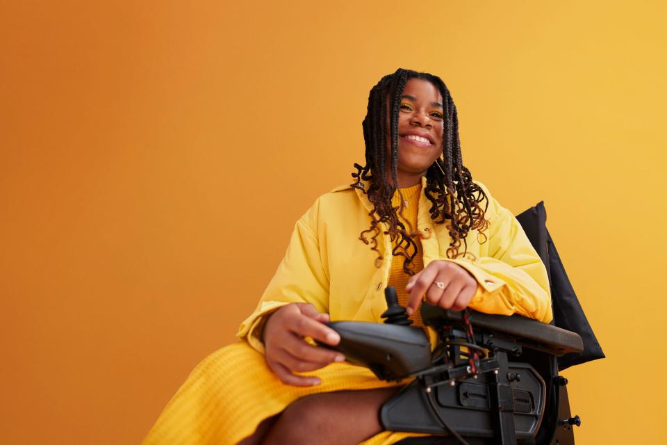 a woman in a yellow outfit in front of yellow background