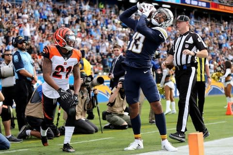 Los Angeles Chargers wide receiver Keenan Allen (13) celebrates a touchdown pass as Cincinnati Bengals defensive back Darqueze Dennard (21) watches in the first quarter of an NFL football game - Credit: Kareem Elgazzar/The Cincinnati Enquirer