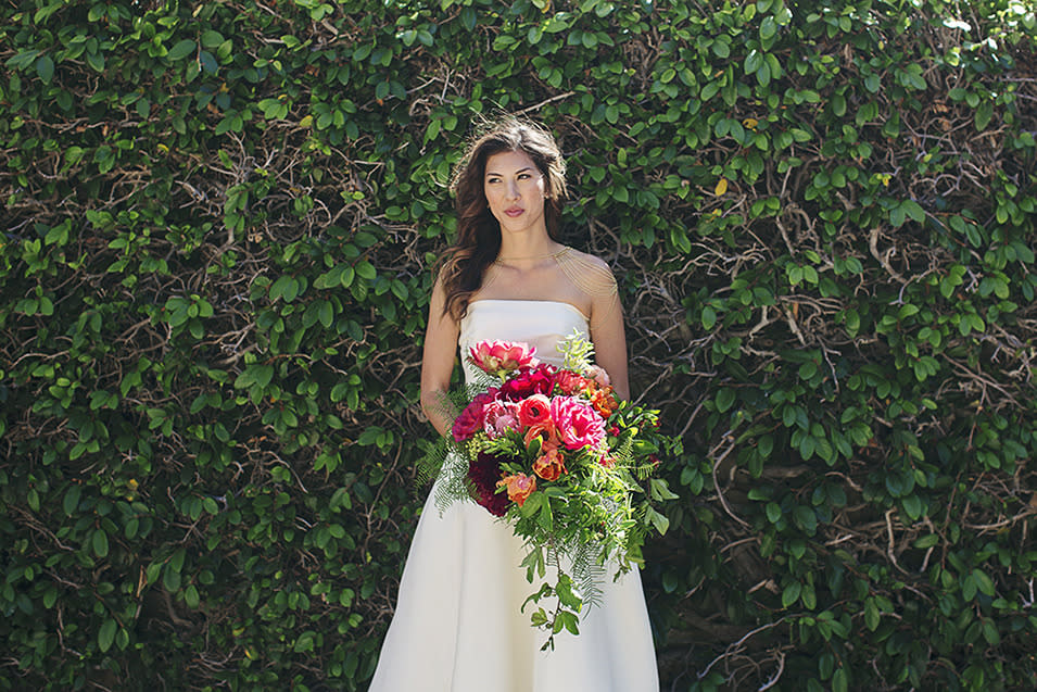 The bride poses with her wedding bouquet.