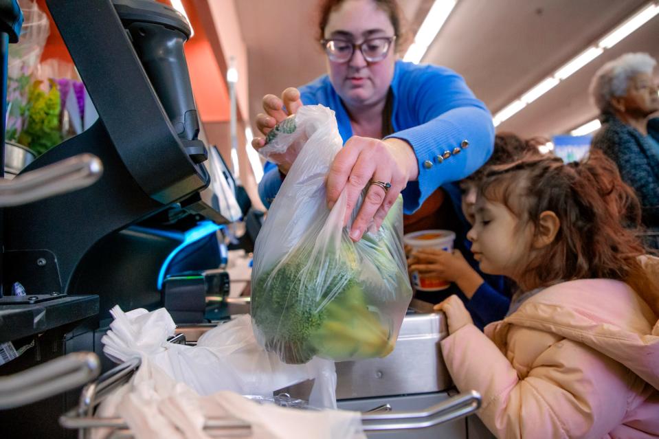 Mollie Reid shops for groceries with her children, Oliver and Skye, in Oklahoma City.