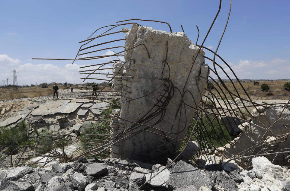 Syrian army soldiers stand guard near the town of Alhureyeh, Syria, Tuesday, Aug. 14, 2018. The Russian military said Tuesday that its forces in Syria will help U.N. peacekeepers fully restore patrols along the frontier with the Israeli-occupied Golan Heights, reflecting Moscow's deepening role in mediating between the decades-old foes. (AP Photo/Sergei Grits)