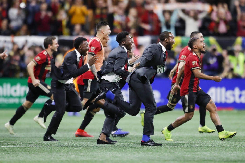 Members of Atlanta United charge the field as the game concludes in the MLS Cup championship soccer game against the Portland Timbers, Saturday, Dec. 8, 2018, in Atlanta. Atlanta United won 2-0. (AP Photo/Todd Kirkland)