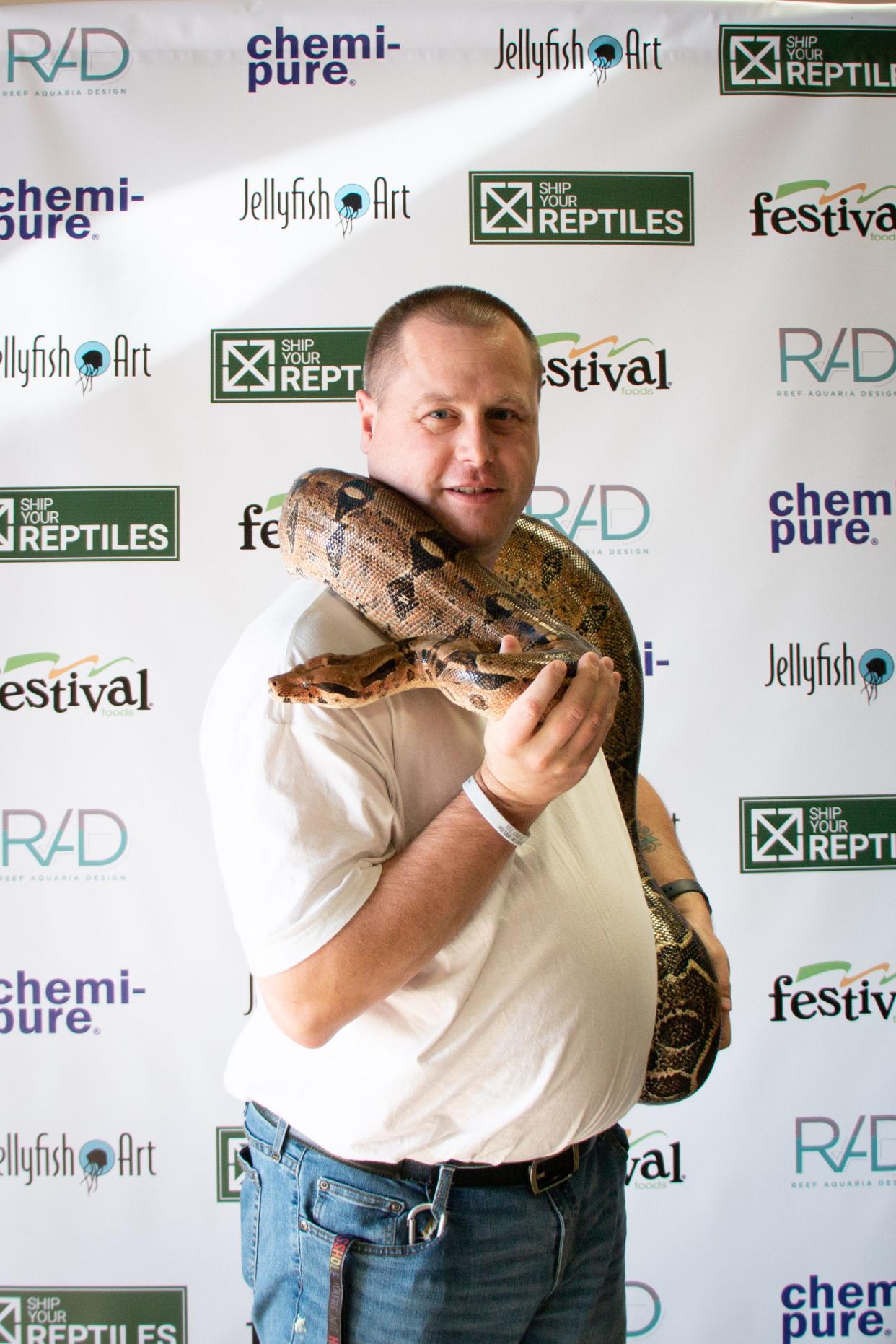 David Cobbs of Reptile Rescue of Wisconsin holds a rescued snake.