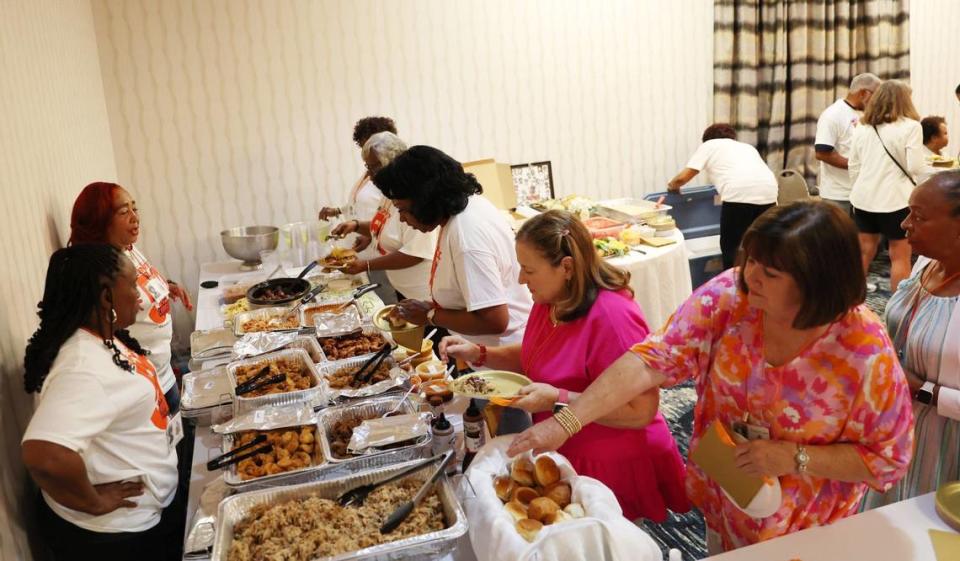 Reunion attendees grab food in the buffet at the Central High School class of 1974 50th reunion on Friday, June 21, 2024, at the Wingate by Wyndham Macon in Macon, Georgia. The class of 1974 was the first graduating class to attend all four years at Central High School, which was established in response to the integration of Bibb County Schools in 1970 by combining A.L. Miller and Lanier High School.