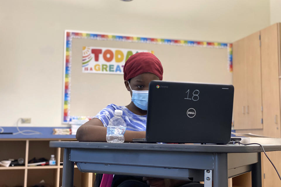 Image: Halima Madey, now 12, works at her computer during an in-person class at Witch Hazel Elementary in June 2021. Schools like Witch Hazel, which has a high number of low-income students, could get more money from the federal government if the Biden Ad (Lillian Mongeau / The Hechinger Report)