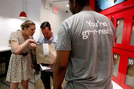 Guests receive their cereal order at the Kellogg's NYC cafe in Midtown Manhattan in New York City, U.S., June 29, 2016. REUTERS/Brendan McDermid