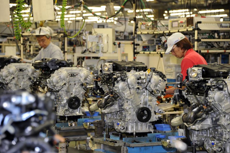 factory workers assemble nissan vq v6 engine