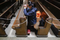 A parishioner prays in nearly empty pews after a Spanish-language Mass at Saint Bartholomew Roman Catholic Church, Monday, July 6, 2020, in the Queens borough of New York. (AP Photo/John Minchillo)