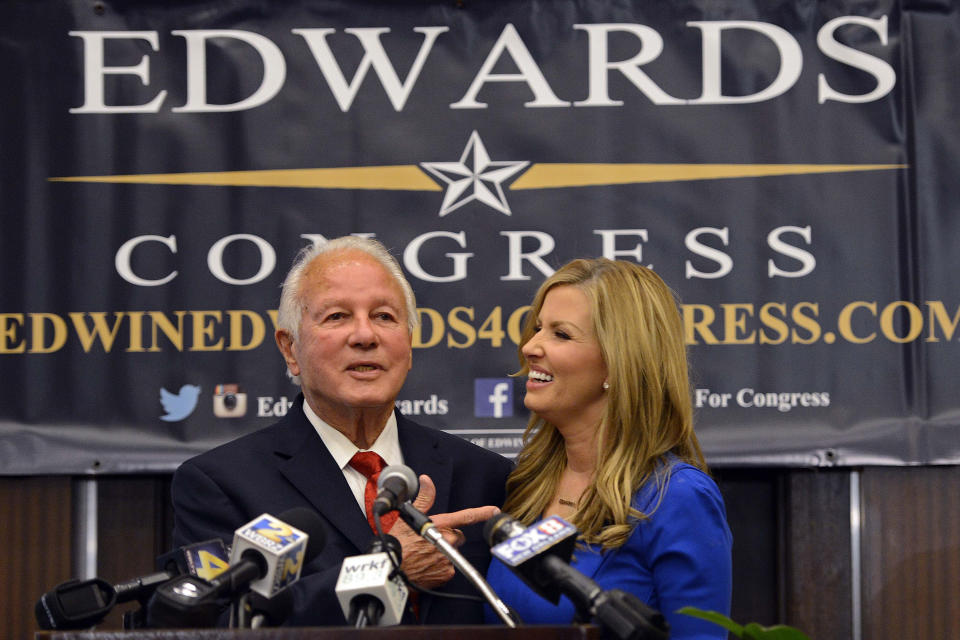 FILE - Louisiana congressional candidate former Louisiana Gov. Edwin Edwards, joined with his wife Trina Edwards, addresses the crowd during his election watch party in Baton Rouge, La., in this Tuesday, Nov. 4, 2014, file photo. Edwin Washington Edwards, the high-living four-term governor whose three-decade dominance of Louisiana politics was all but overshadowed by scandal and an eight-year federal prison stretch, died Monday, July 12, 2021 . He was 93. Edwards died of respiratory problems with family and friends by his bedside, family spokesman Leo Honeycutt said. He had suffered bouts of ill health in recent years and entered hospice care this month at his home in Gonzales, near the Louisiana capital.(AP Photo/Bill Feig, File)