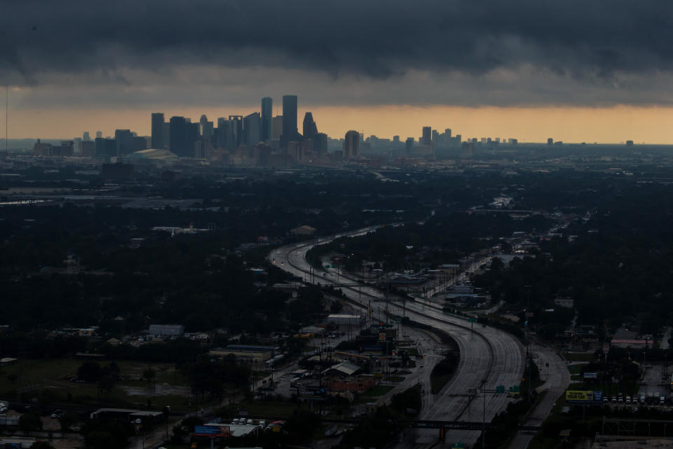 An aerial view of downtown Houston under dark clouds.