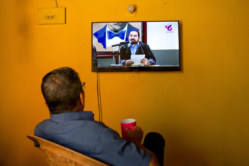 FILE PHOTO: A man watches a local TV channel streaming the news conference of Magistrate Octavio Rothschuh announcing the release of political prisoners to the U.S., in Managua