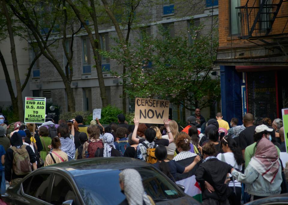 FIT students march from the campus museum to the new encampment.