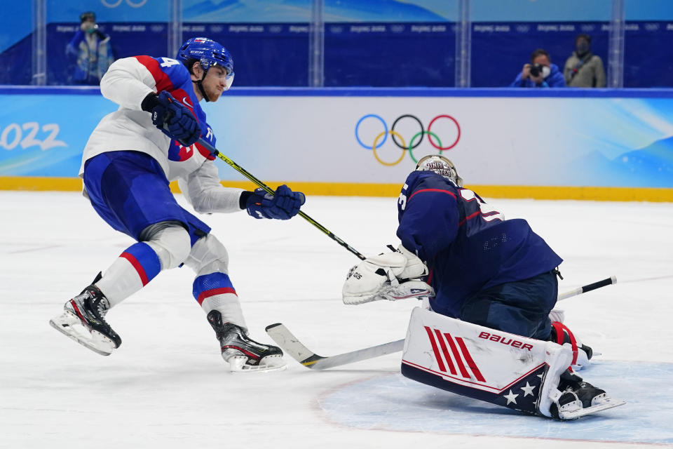 Slovakia's Peter Cehlarik, left, scores the winning goal past United States goalkeeper Strauss Mann (31) during a shoot-out in a men's quarterfinal hockey game at the 2022 Winter Olympics, Wednesday, Feb. 16, 2022, in Beijing. Slovakia won 3-2. (AP Photo/Matt Slocum)