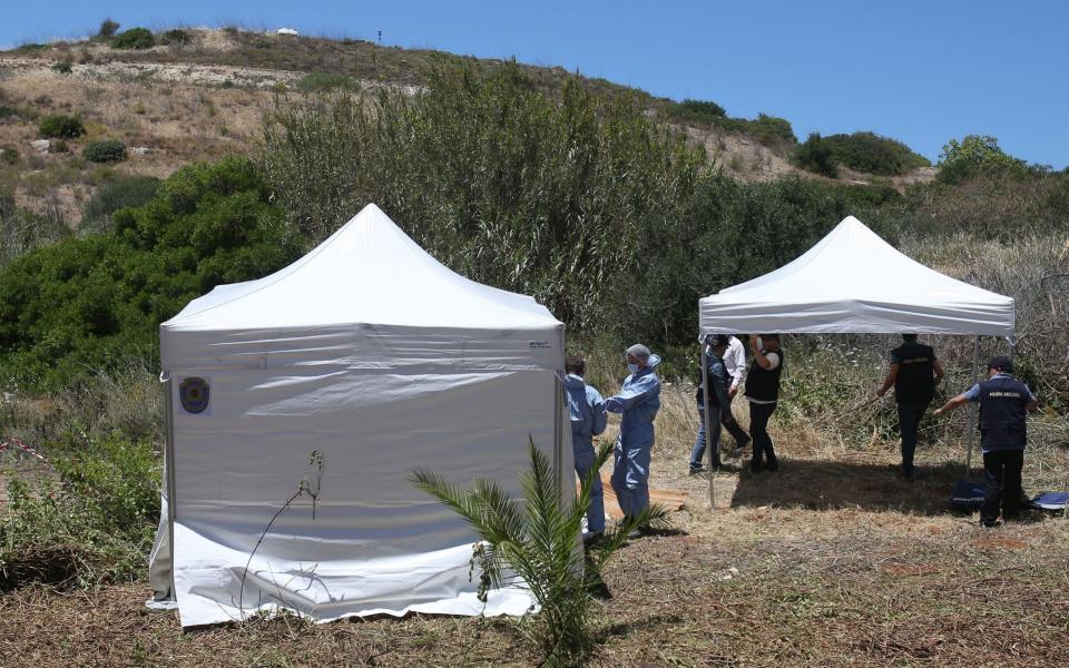 June 2014: Forensic police officers dig up wasteland to search for Madeleine McCann in the town of Praia da Luz  - PA