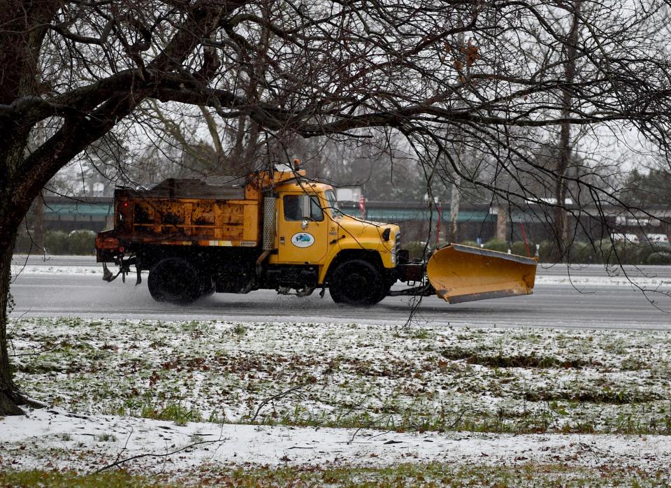 A snow plow drives along Ocean Gateway during a winter storm Monday, Jan. 3, 2022, in Salisbury, Maryland.