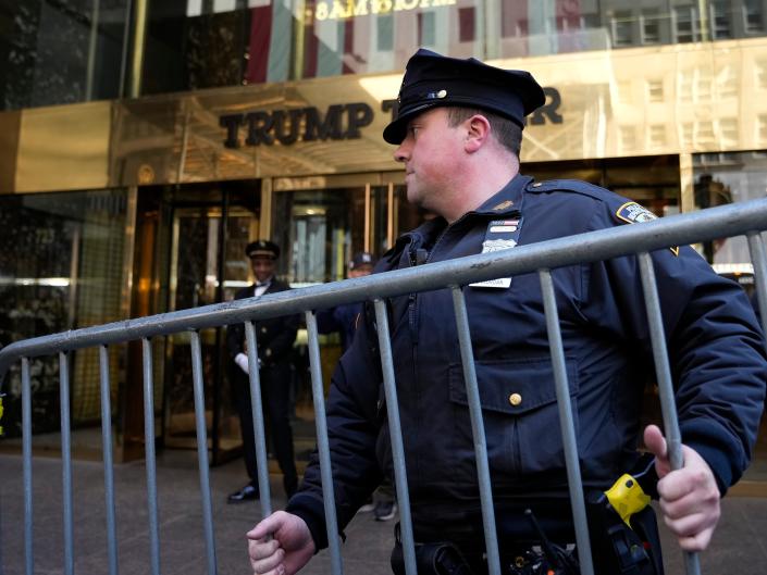 A police officer places a barricade in front of Trump Tower, on Tuesday, March 21, 2023, in New York.