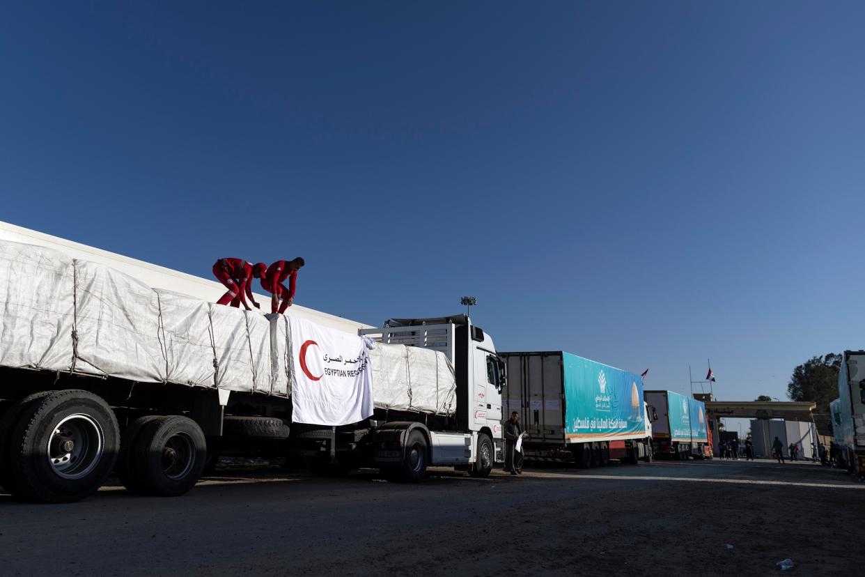 Egyptian Red Crescent members prepare an aid convoy truck to cross the Rafah border from the Egyptian side (Getty Images)