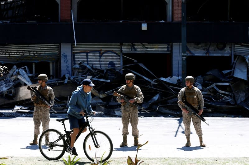 Soldiers patrol the street one day after a protest against the government in Valparaiso