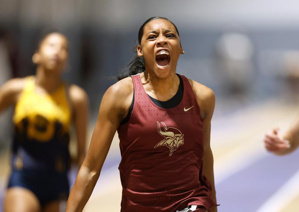 Pittsford Mendon’s Tamara Dorval, a member of Haiti's national team, celebrates winning the 55-meter dash during the Section V state qualifier meet.