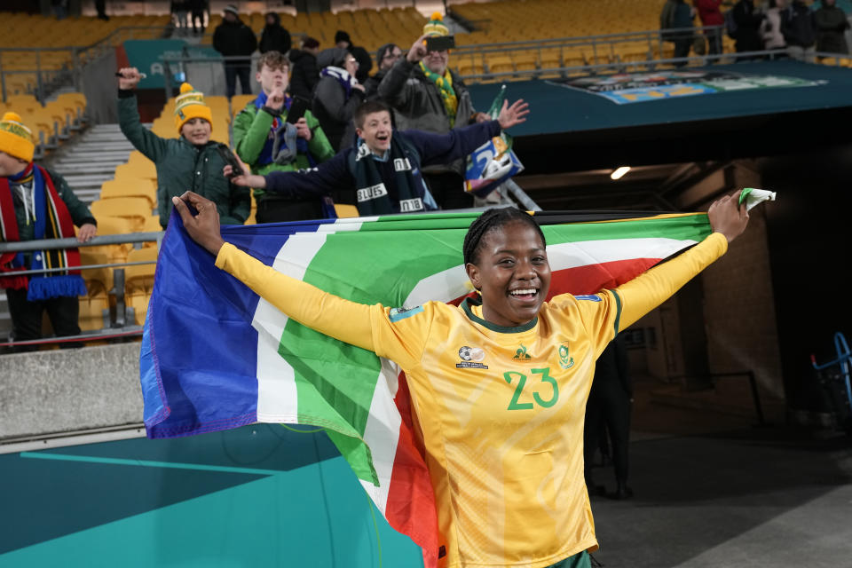 South Africa's Wendy Shongwe celebrates with the national flag after the Women's World Cup Group G soccer match between South Africa and Italy in Wellington, New Zealand, Wednesday, Aug. 2, 2023. (AP Photo/Alessandra Tarantino)