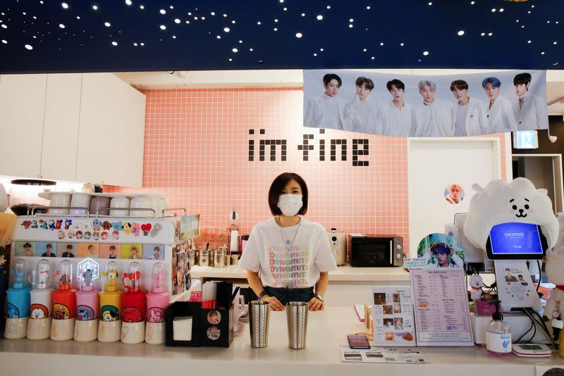 Cafe owner Kim Eun-hee, fan of K-pop boy band BTS, speaks to Reuters during an interview in her cafe in Seoul