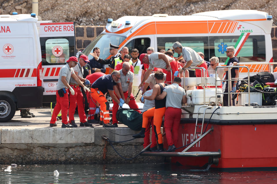 Emergency services carry a body bag after a sailboat sank in the early hours of Monday, off the coast of Porticello, near the Sicilian city of Palermo, Italy, August 19, 2024. REUTERS/Igor Petyx