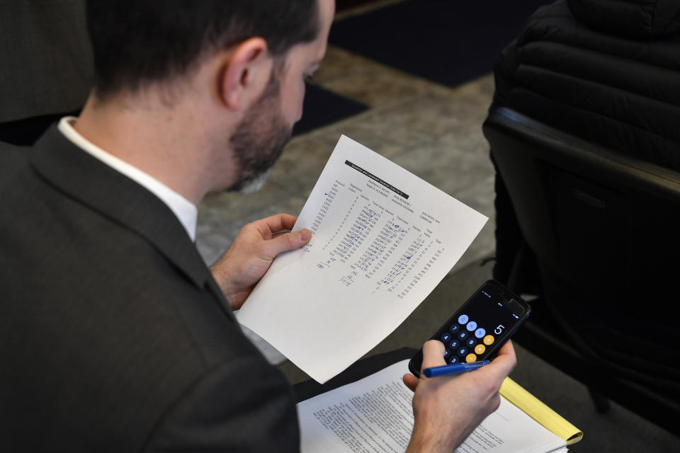 A member of the republican party checks the math on the vote totals from Anderson County, Ky., during the remcanvass of the Kentucky Governors race in Lawrenceburg, Ky., Thursday, Nov. 14, 2019. Election officials across Kentucky have started double-checking vote totals that show Republican Gov. Matt Bevin trailing Democrat Andy Beshear by more than 5,000 votes. (AP Photo/Timothy D. Easley)