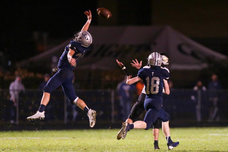 Central Catholic's Brinn Robbins (23) goes up to break up a pass intended for South Vermillion's Dalton Payton (34) in front of Central Catholic's Nick Page (18) during the third quarter of an IHSAA football game, Friday, Oct. 22, 2021 in Lafayette.