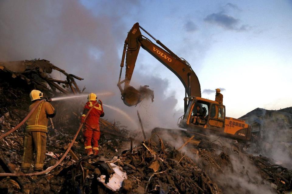 Iranian firefighters remove the debris of the Plasco building which collapsed on Thursday, in central Tehran, Iran, Sunday, Jan. 22, 2017. Scores of workers and dozens of trucks were searching the ruins Saturday, three days after the historic high-rise building in the heart of Tehran caught fire and later collapsed. (AP Photo/Ebrahim Noroozi)