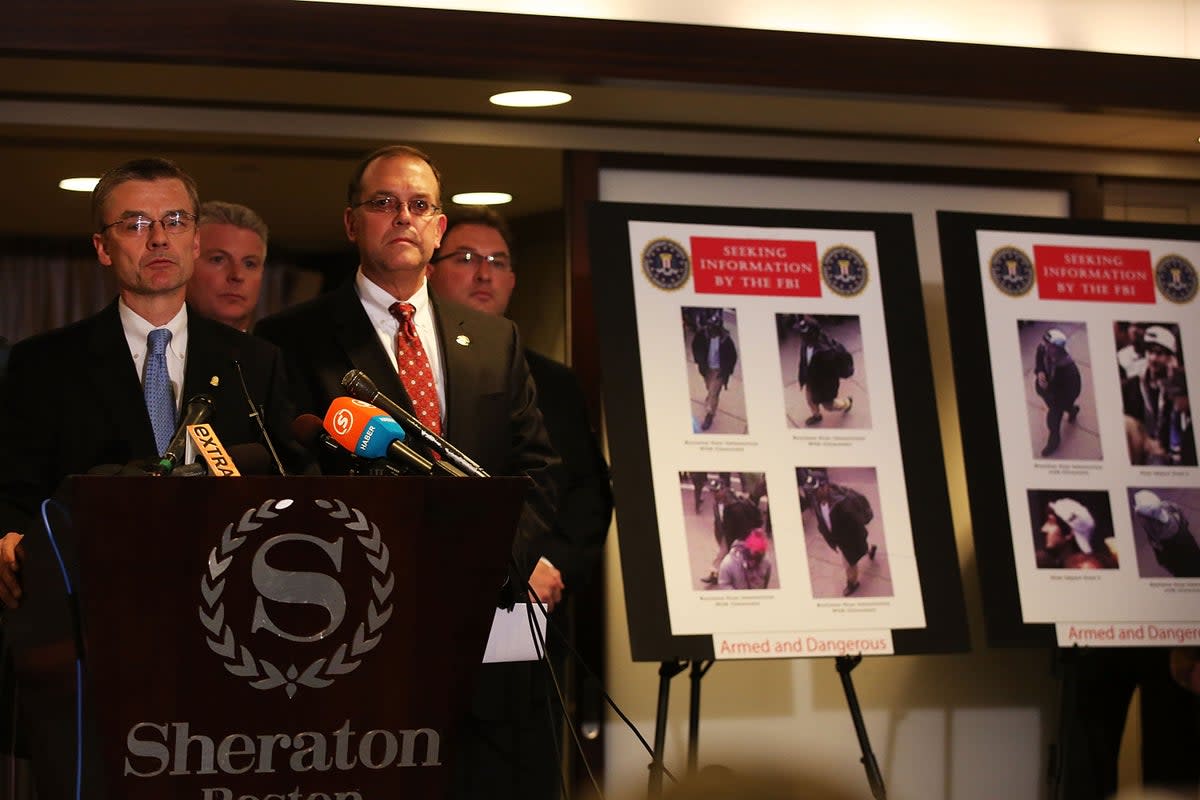 FBI Special Agent Richard DesLauriers and other investigators release images taken from a security camera of persons of interest in the Boston Marathon bombings during a news conference on 18 April 2013 in Boston, Massachusetts (Spencer Platt/Getty Images)