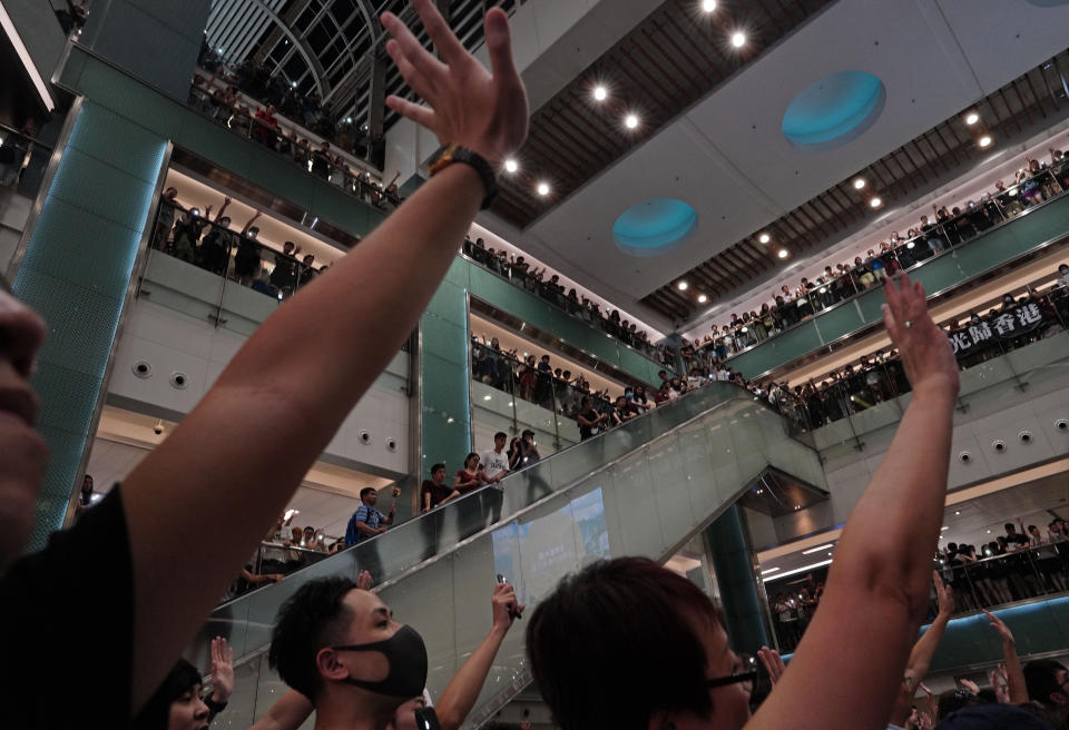 Local residents sing a theme song written by protesters "Glory be to thee" at a shopping mall in Hong Kong Wednesday, Sept. 11, 2019. Hong Kong Chief Executive Carrie Lam reassured foreign investors Wednesday that the Asian financial hub can rebound from months of protests, despite no sign that the unrest will subside. (AP Photo/Vincent Yu)