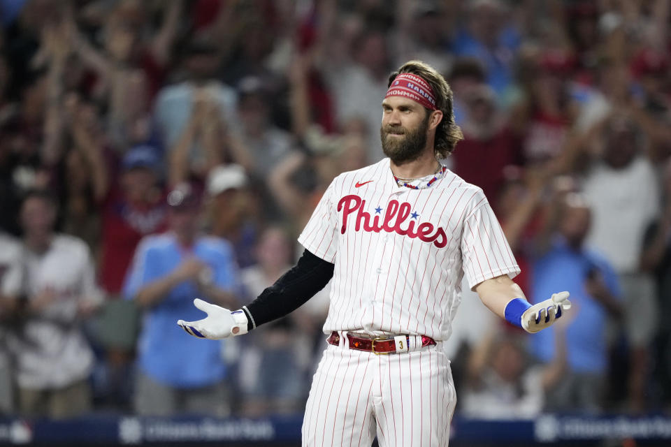 Philadelphia Phillies' Bryce Harper reacts after hitting an inside-the-park home run against San Francisco Giants pitcher Sean Hjelle during the fifth inning of a baseball game, Monday, Aug. 21, 2023, in Philadelphia. (AP Photo/Matt Slocum)