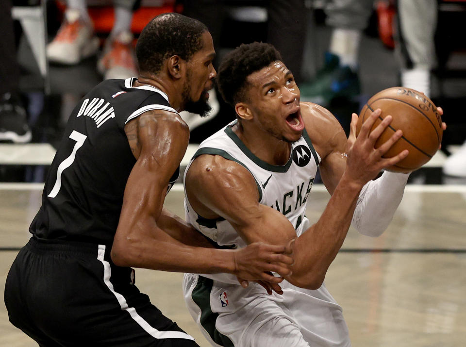 NEW YORK, NEW YORK - JUNE 19: Giannis Antetokounmpo #34 of the Milwaukee Bucks heads for the net as Kevin Durant #7 of the Brooklyn Nets defends in the second half during game seven of the Eastern Conference second round at Barclays Center on June 19, 2021 in the Brooklyn borough of  New York City. NOTE TO USER: User expressly acknowledges and agrees that, by downloading and or using this photograph, User is consenting to the terms and conditions of the Getty Images License Agreement. (Photo by Elsa/Getty Images)