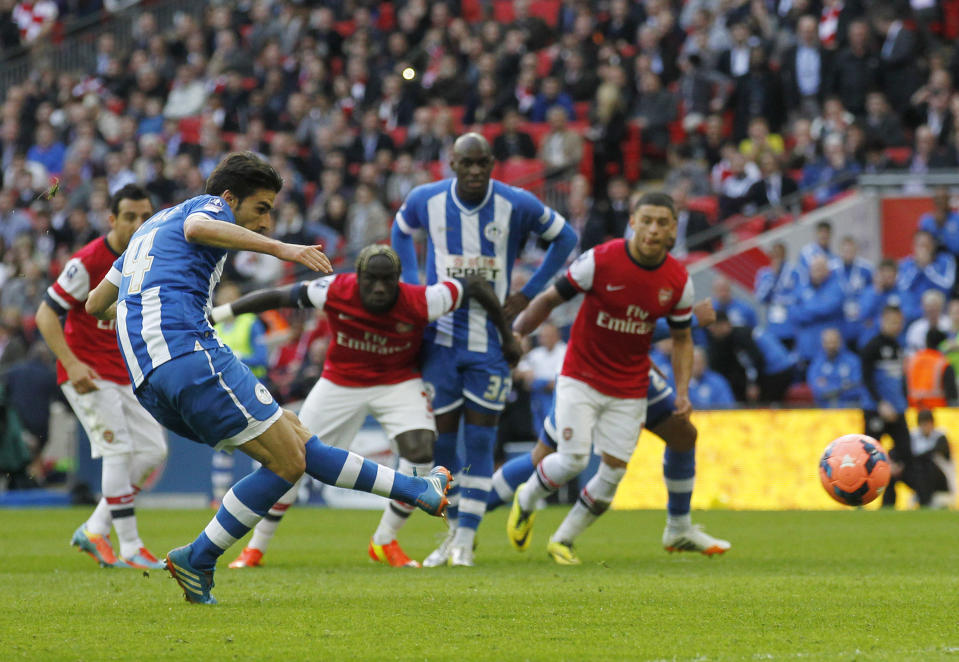 Wigan Athletic's Jordi Gomez scores a penalty against Arsenal during their English FA Cup semifinal soccer match at Wembley Stadium in London, Saturday, April 12, 2014. (AP Photo/Sang Tan)