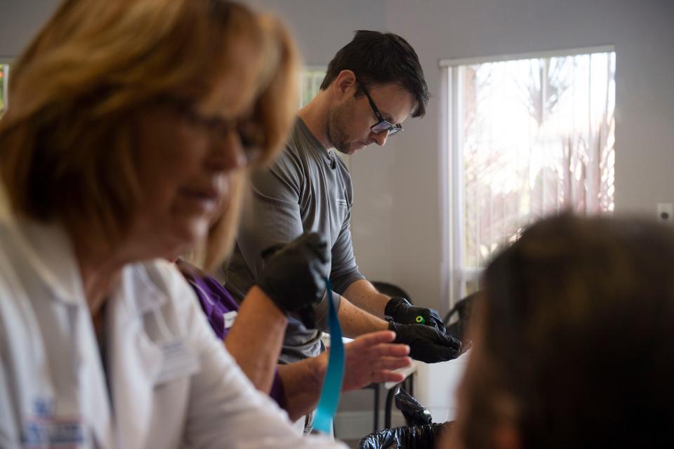 Florida Atlantic University's Harbor Branch Oceanographic Institute researcher Adam Schaefer, epidemiologist, helped collect blood, urine and nasal swab samples Friday, Sept. 14, 2018 at the Florida Sportsman magazine office in Stuart. A group of researchers is testing people who live and work around blue-green algae blooms in the St. Lucie River and have found detectable levels of the toxin microcystin in the noses of over 70 people tested. 