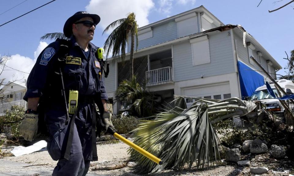 A firefighter walks towards another home looking for any signs of life in Cudjoe Key.