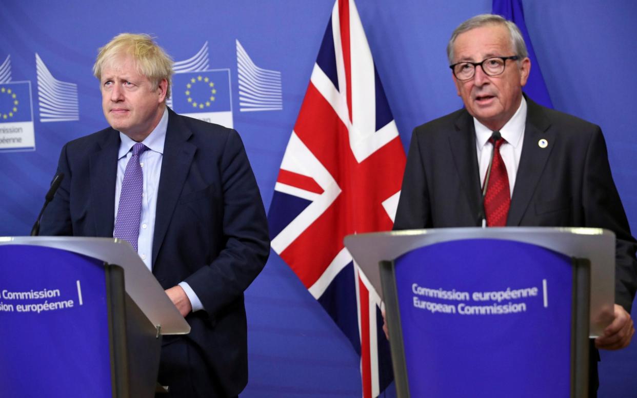 Boris Johnson (left) speaks alongside European Commission President Jean-Claude Juncker - AP