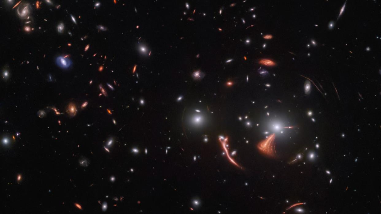  Wide-field telescope view showing dozens of distant galaxies. 