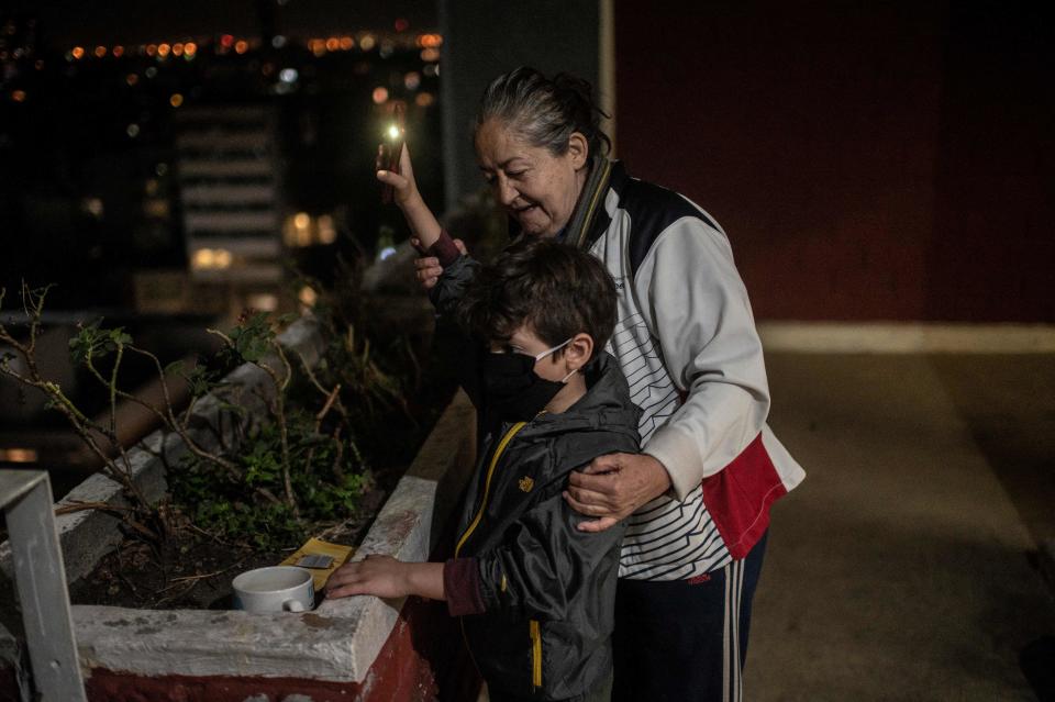 Residents of a building across the "20 de Noviembre" hospital sing and wave lights to praise medical staff and patients in Mexico City, on April 28, 2020, amid the novel coronavirus pandemic. - Latin America is like "Europe six weeks ago" in relation to the advance of COVID-19, so an increase in the number of cases is expected in the coming weeks, warned on April 28 the deputy director of the Pan American Health Organization (PAHO), Jarbas Barbosa. (Photo by PEDRO PARDO / AFP) (Photo by PEDRO PARDO/AFP via Getty Images)