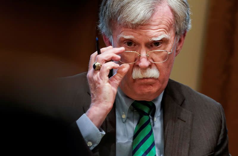 FILE PHOTO: National Security Advisor Bolton listens as U.S. President Trump speaks while meeting with NATO Secretary General Stoltenberg at White House in Washington