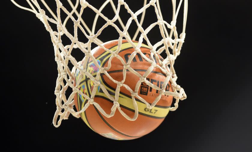 A picture taken on August 30, 2014 shows an official ball of the 2014 FIBA World basketball championships in the net at the Gran Canaria Arena in Gran Canaria. AFP PHOTO / GERARD JULIEN (Photo credit should read GERARD JULIEN,GERARD JULIEN/AFP via Getty Images)