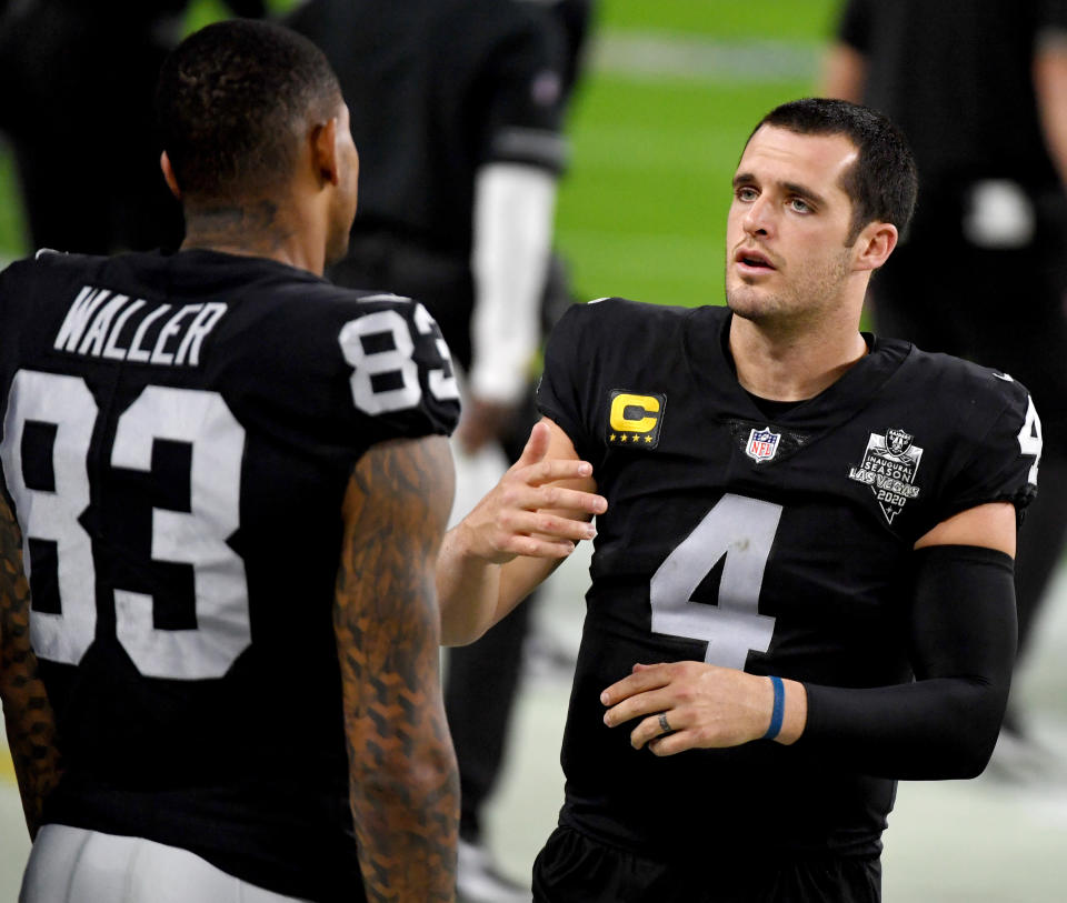 LAS VEGAS, NEVADA - DECEMBER 26:  Quarterback Derek Carr #4 of the Las Vegas Raiders talks with tight end Darren Waller #83 on the sideline in the first half of their game against the Miami Dolphins at Allegiant Stadium on December 26, 2020 in Las Vegas, Nevada. The Dolphins defeated the Raiders 26-25.  (Photo by Ethan Miller/Getty Images)