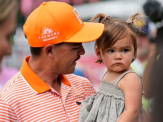 <p>Raj Mehta/Getty</p> Rickie Fowler celebrates with his daughter, Maya, after winning the Rocket Mortgage Classic in a playoff at Detroit Golf Club on July 02, 2023.