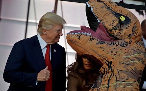 U.S. President Donald Trump and First Lady Melania Trump give out Halloween treats to children in Washington - Credit: Reuters